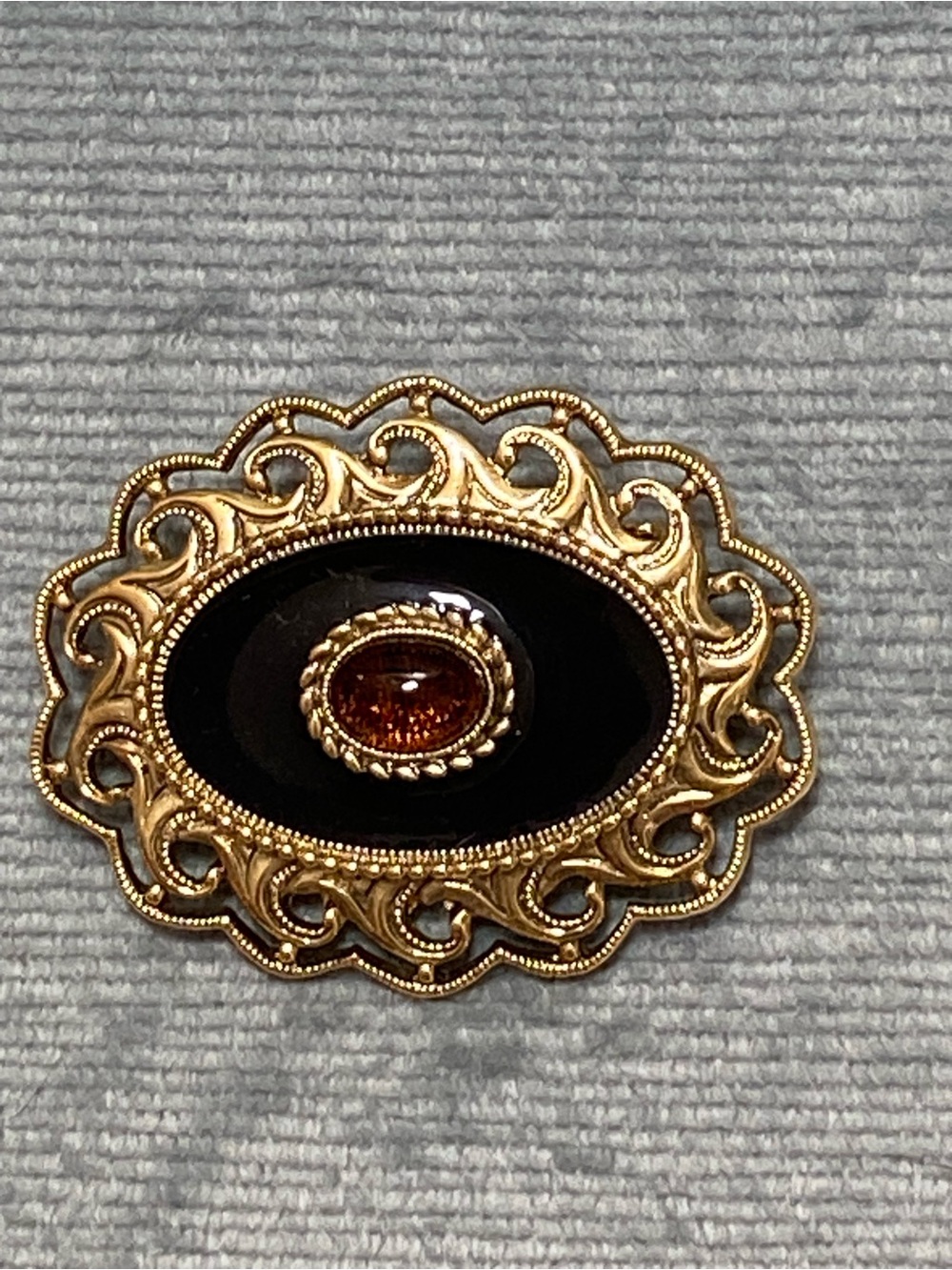 1928 Company Gold-Tone Filigree Brooch with Black Enamel Amber Cabachon Stone